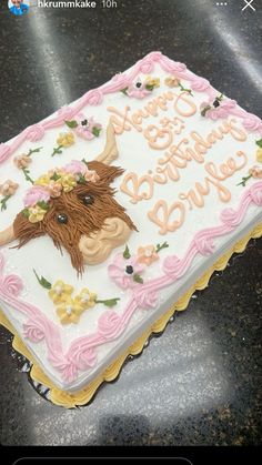 there is a birthday cake that looks like a cow with flowers on it's head