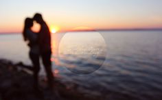 two people standing next to each other near the ocean at sunset or sunrise with text overlaying them