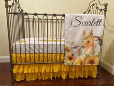 a baby crib with yellow ruffled bedspread and two dogs on it