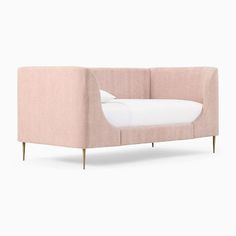 a pink couch sitting on top of a white floor