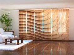 a living room filled with furniture next to a window covered in wooden slat panels