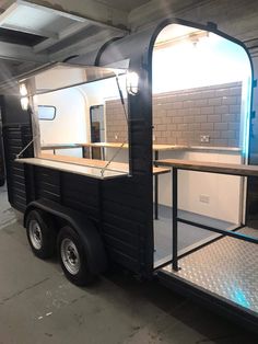 a black food truck parked in a garage