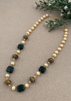 Step into a world of timeless charm with our "Timeless Charm" Traditional Antique Mala, meticulously crafted to celebrate the grandeur of traditional Indian jewelry. This mala features a combination of intricate beads, lush green hydro beads, and lustrous pearls, making it the perfect choice for adding traditional elegance to your attire, whether it's for weddings, special occasions, or cultural celebrations. Materials: Traditional Elements: The mala incorporates traditional Indian design elemen Intricate Design Pearl Necklace As Festival Gift, Classic Gold Necklace With Gemstone Beads, Festive Pearl Necklace With Intricate Design As Gift, Festival Gift Pearl Necklace With Intricate Design, Traditional Necklaces For Diwali, Diwali Dual-tone Round Necklace, Traditional Green Dual-tone Necklace, Spiritual Gold Bridal Necklace With Round Beads, Spiritual Gold Kundan Necklace With Polished Beads