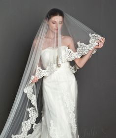 a woman in a wedding dress with a veil on her head