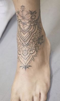 a close up of a person's foot with a tattoo on the top of it