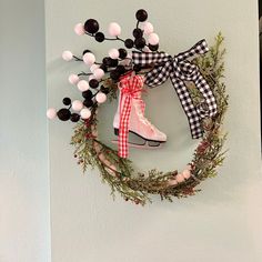 a wreath with some decorations hanging on the wall next to a pair of roller skates