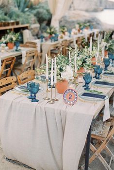 an outdoor dining area with tables, chairs and place settings for guests to sit at