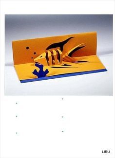 an origami card with a fish on the front and bottom, in blue and yellow