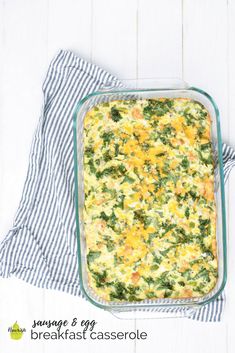 a casserole dish with broccoli and cheese in it on a white table