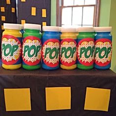 five jars with pop pop on them sitting on a table