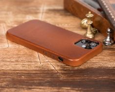 a brown leather case sitting on top of a wooden table next to a bottle opener