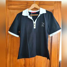 Elevate Your Workwear Wardrobe With This Stunning Cellini Polo Shirt. The Black Cotton Blend Material Is Machine Washable And Features A Solid Pattern With Short Sleeves And A Collared Neckline. The Pullover Closure And Button Accents Add A Touch Of Sophistication To This Vintage Piece, Which Is Perfect For Summer, Fall, And Spring Seasons. New With Tags. Made In Italy. Armpit To Armpit - 20 In. Shoulder To Hem - 23 In. Poli Shirts Women, Sporty Team-colored Short Sleeve Polo Shirt, Polo Shirt Colors, Polo Shirt Women, Spring Season, Size 12, Black Cotton, Work Wear, Polo Shirt