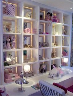 a room filled with lots of shelves and stuffed animals on top of it's sides