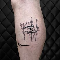 a black and white tattoo on the leg of a person