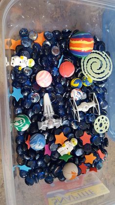 a plastic container filled with lots of different types of buttons