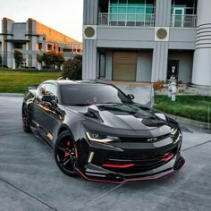 the chevrolet camaro is parked in front of a building