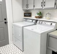 a white washer and dryer sitting next to each other in a laundry room