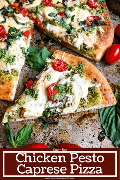 two slices of pizza with tomatoes, cheese and basil on a baking sheet next to cherry tomatoes