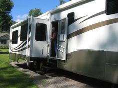 an rv parked on the side of a road with its driver looking out the window