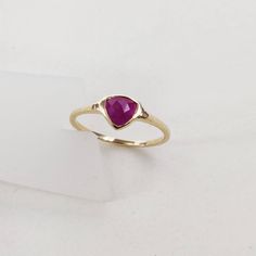 **KINDLY CHECK OUT THE VIDEO OF THE ITEM FOR A CLEARER VIEW**Details of the ring Gem: Ruby Gem size & shape: 6 mm, Trillion gem wt: 0 .68 carats Checkerboard cut Natural ruby Gold purity: 14K (58.33% approx.) Gold weight: 1.22 grams total weight of ring: 1.36 grams Ring size: us 6 1/2 Ring size us 6 Fine checkerboard cut natural Ruby gemstone ring set in solid 14K yellow gold. The ring has a fine hammered texture which looks absolutely chic and beautiful on the finger. The Gold purity is gua Modern Diamond Ring With Gemstone Accents, Promise Ruby Ring In 14k Gold, Ethically Sourced, Fine Jewelry Ruby Gemstone Stackable Rings, 14k Gold Jewelry With Trillion Cut Accent Stones, Fine Jewelry Faceted Promise Ring, Fine Jewelry Ruby Ring For Promise, Fine Jewelry Ruby Ring For Promise Occasion, 14k Gold Faceted Sapphire Ring Fine Jewelry, Yellow Gold Ruby Ring In Sterling Silver