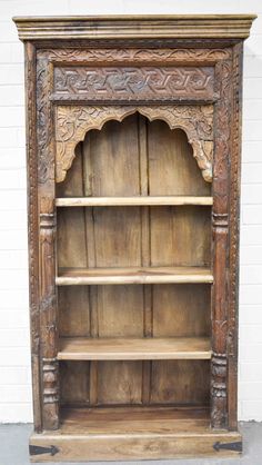 an old wooden bookcase with carvings on it