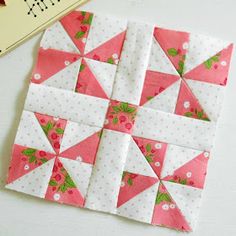 a piece of pink and white quilt next to a ruler