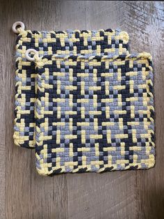 a woven pouch sitting on top of a wooden table