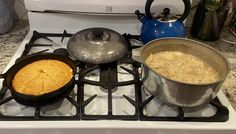 pots and pans sitting on top of a stove with food cooking in them next to each other