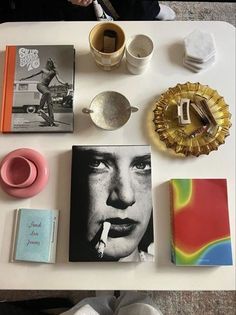 a table topped with books and other items on top of it's white surface