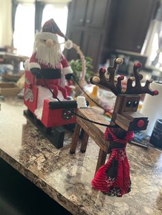 two wooden reindeer sleighs sitting on top of a counter