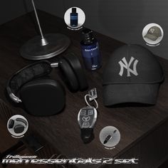 a baseball cap, keys, and other items are on a wooden table with the new york yankees logo