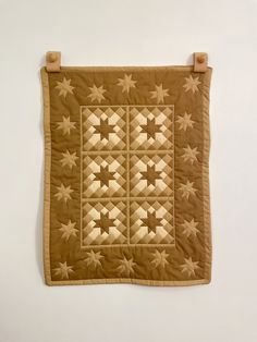 a quilted wall hanging with stars on it