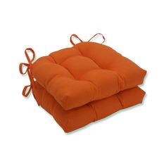 two orange cushions sitting on top of each other