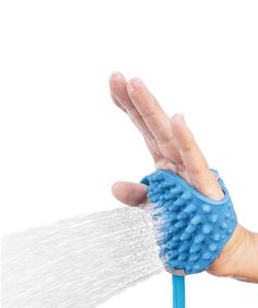 a person's hand holding a blue scrubber with water coming out of it