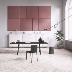 an office with pink and white walls, black chairs and a wooden table in the middle