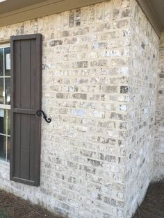 an open window on the side of a brick building