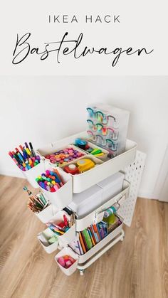 a white cart filled with lots of crafting supplies on top of a wooden floor