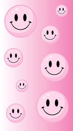 a pink background with many smiley faces on it