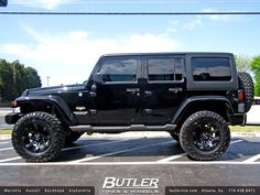 a black jeep parked in a parking lot