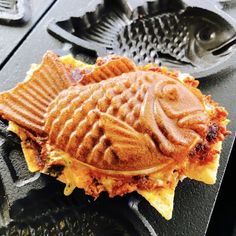 a waffle with some kind of fish on it sitting on top of a grill