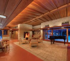 a living room filled with furniture and a piano