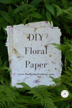 a sign that says diy floral paper in front of some green plants and leaves