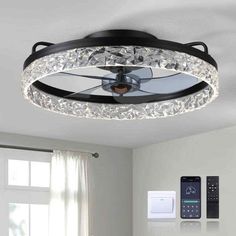 a ceiling light that is in the middle of a room with a remote control on it