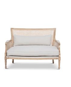 a white couch sitting on top of a wooden frame