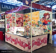 a booth with anime posters on it