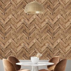 two chairs and a table in front of a wall with woven wood panels on it