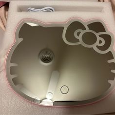 a hello kitty shaped bathroom sink with pink trimmings on the top and bottom