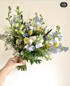 a person holding a bouquet of flowers in their hand