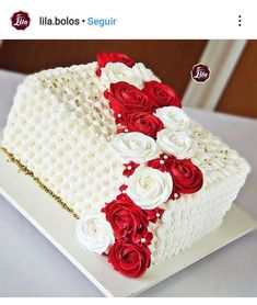 a white cake with red and white flowers on it