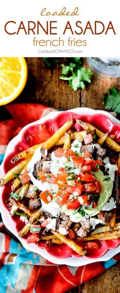 a red plate topped with french fries covered in toppings